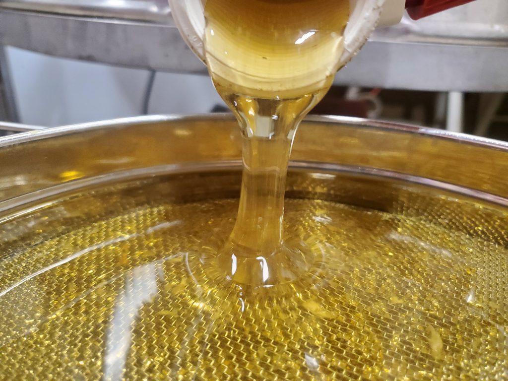 Local Raw Michigan Honey coming out of honey extractor